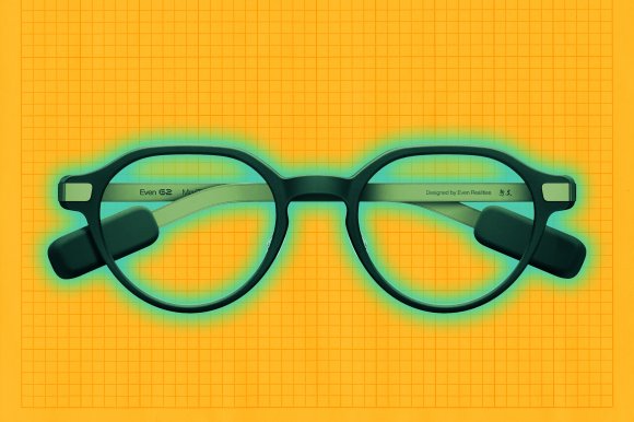 Round black Even Realities G2 live-caption eyeglasses with thick frames and attached black rectangular sensors on the temples, placed on an orange grid background.