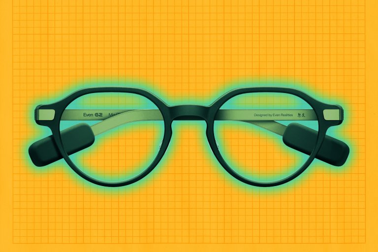 Round black Even Realities G2 live-caption eyeglasses with thick frames and attached black rectangular sensors on the temples, placed on an orange grid background.