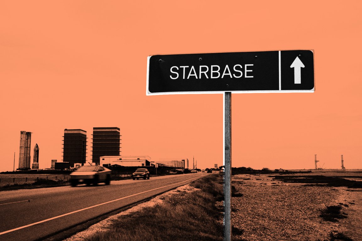 A road sign with the word "STARBASE" and an upward-pointing arrow is positioned beside a highway. In the background, there are industrial buildings and structures, including two large, rectangular buildings and a rocket-like structure. The sky has an orange tint.