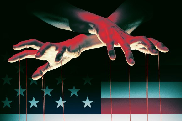A graphic illustration featuring two puppeteer hands with their strings dangling before them in the foreground and a spotlit American flag behind it.