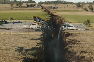 A still from the 2015 disaster film San Andreas, dramatically showing the earth split in half along a fault line.