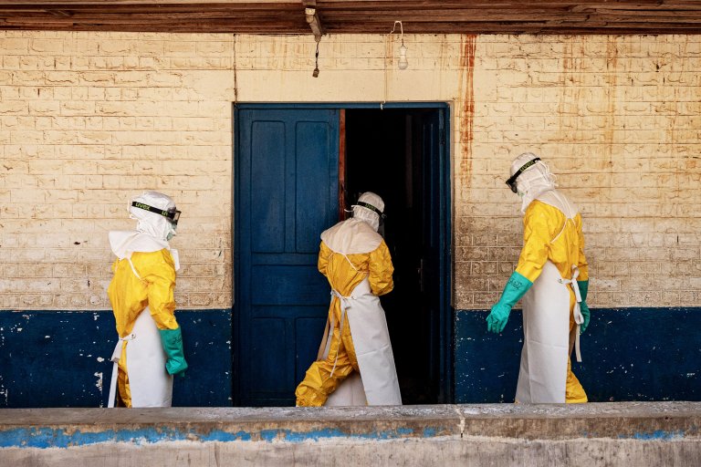Members of the Médecins Sans Frontières (MSF) Ebola response team enter an isolation area outside the General Referral Hospital of Mongbwalu during outbreak preparedness and infection prevention activities.