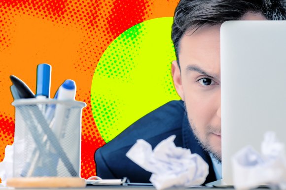 A photo illustration showing a man at his desk hiding behind his laptop and peering out.