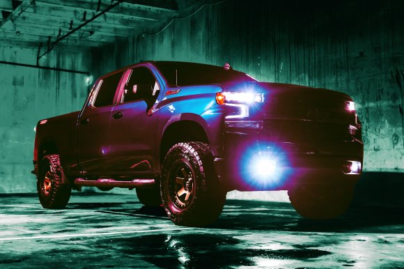 A color-treated photograph featuring a large, menacing 2023 Chevy Z71 with his headlights on.