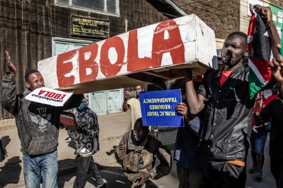 Protesters carry a mock coffin as they march during a demonstration against a controversial US-built Ebola quarantine center.