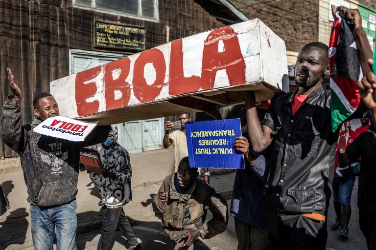 Protesters carry a mock coffin as they march during a demonstration against a controversial US-built Ebola quarantine center.