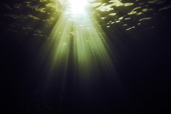 A color treated photograph from underwater suggesting an eerie mystery in the depths of the ocean.