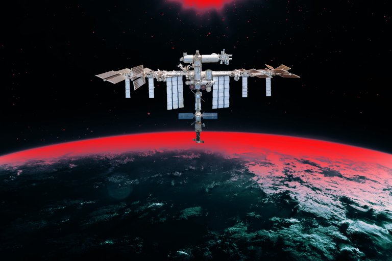 An illustration of the ISS floating above earth backed by an eerie red gradient descending from space.