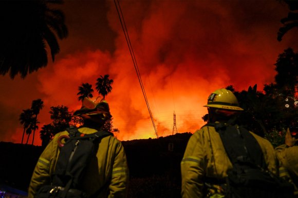 A view of wild fire as firefighting planes and helicopters drop water over flames in Mandeville Canyon during 'Palisades Fire' in Los Angeles, California, United States on January 10, 2025.
