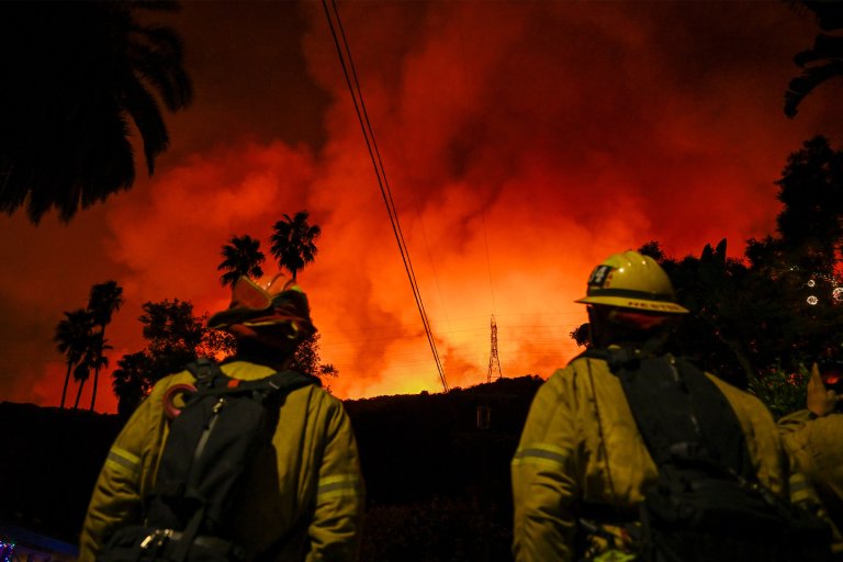 A view of wild fire as firefighting planes and helicopters drop water over flames in Mandeville Canyon during 'Palisades Fire' in Los Angeles, California, United States on January 10, 2025.