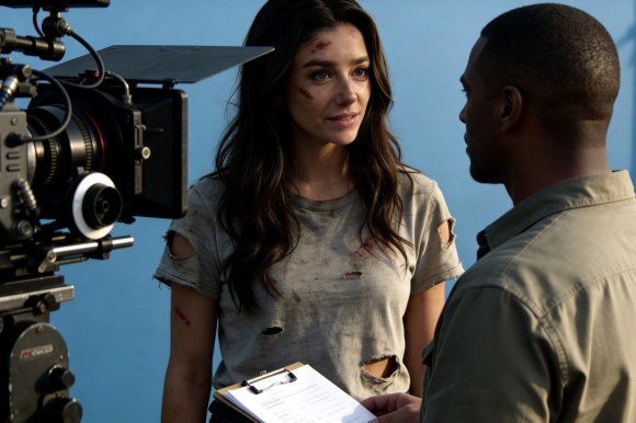 An image of AI-Generated "actress" Tilly Norwood from her website, in which she appears to be talking to a director between scenes.