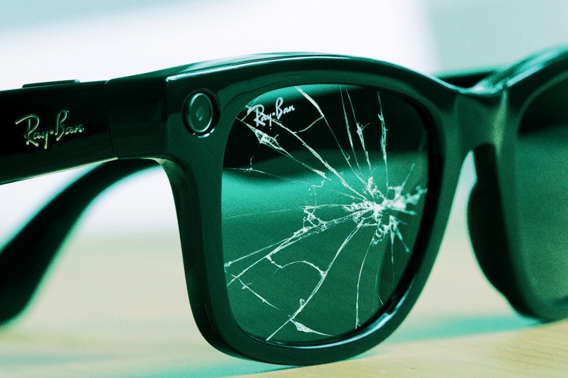 A photo illustration featuring a close-up of a pair of Meta Ray-Ban sunglasses, with one of the lenses cracked.