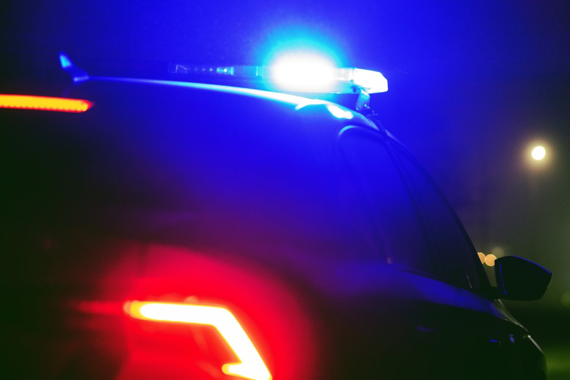 A color-treated photograph of the flashing lights on a police cruiser.