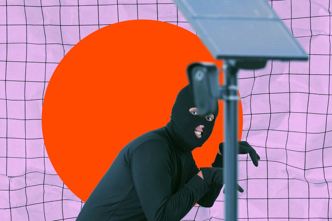 A photo illustration featuring a flock camera in the foreground while a thief in a balaclava sneaks behind it with a smile on his face.