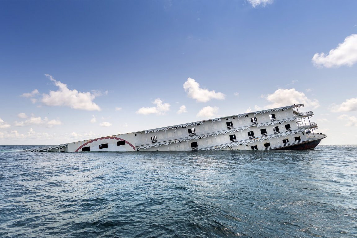 A photograph of the Argosy riverboat casino sinking into the ocean.