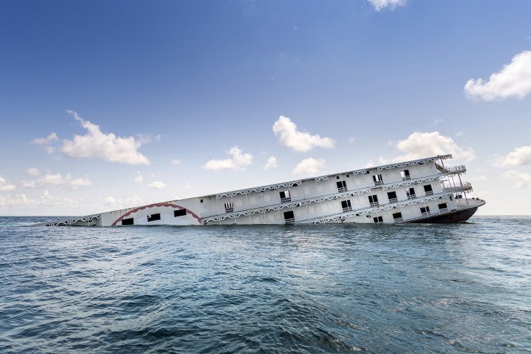A photograph of the Argosy riverboat casino sinking into the ocean.