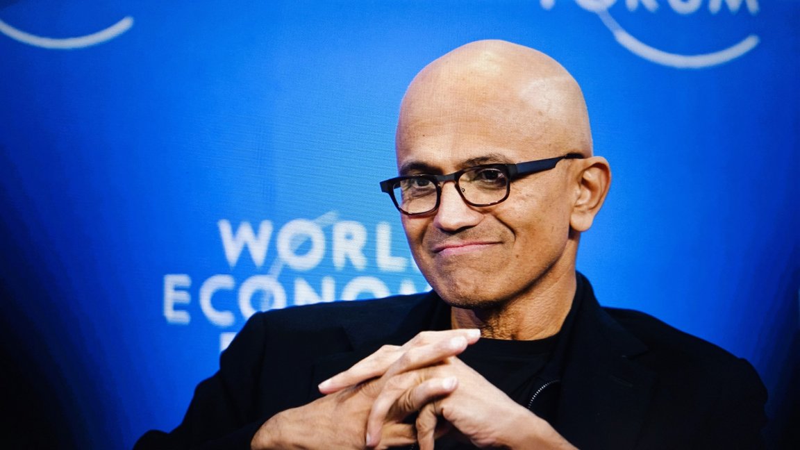 Microsoft Satya Nadella is seen clasping his hands together.