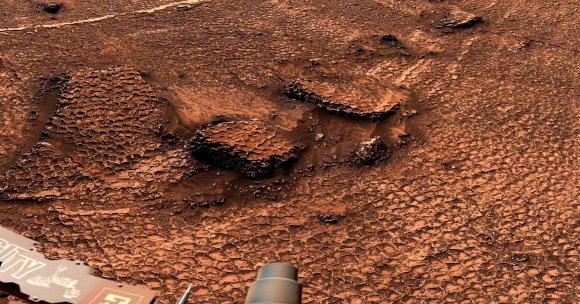 A 360-degree view of an expanse of Martian terrain covered in surface features called polygons, taken by NASA's Curiosity Mars rover.