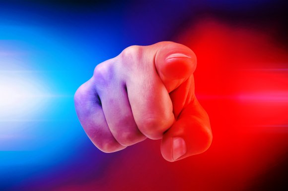An illustration of a hand pointing toward the viewer, surrounded by blue and red police lights.
