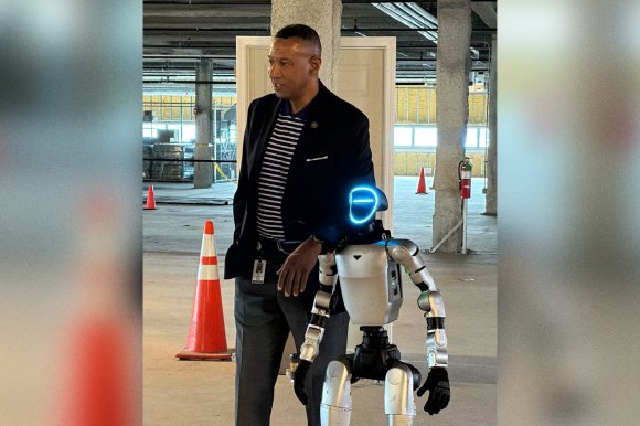 A photograph of Forsyth, N.C. Sherriff Bobby F. Kimbrough with Kimbroid humanoid robot.