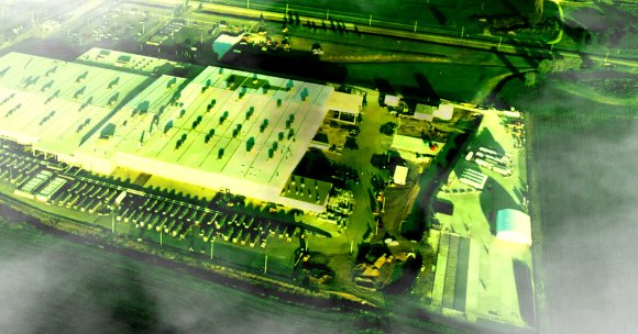 A photo illustration showing xAI's data center, with smoke overlaid.
