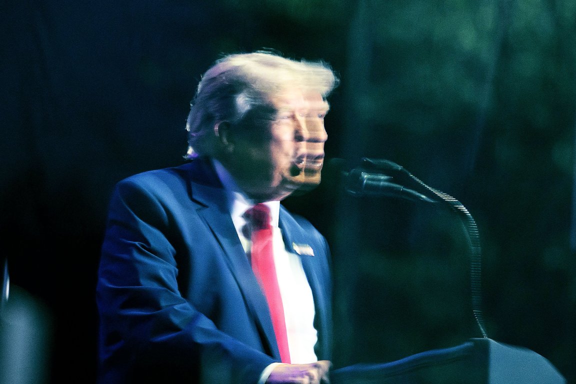 A double image caused by photographing though bulletproof glass shows US President Donald Trump speaking during the kick-off celebration for the "Great American State Fair" on the National Mall in Washington, DC, June 24, 2026.