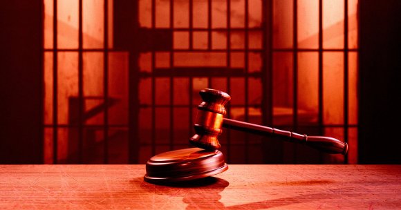 A wooden gavel hits the round block.