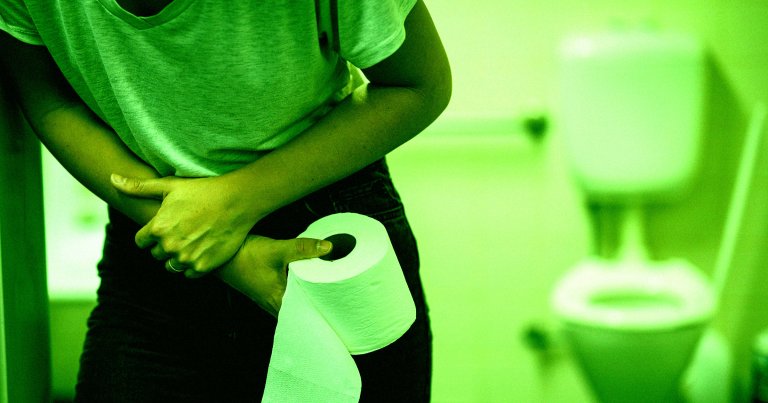 A color treated picture of a woman holding her stomach and a toilet paper roll.