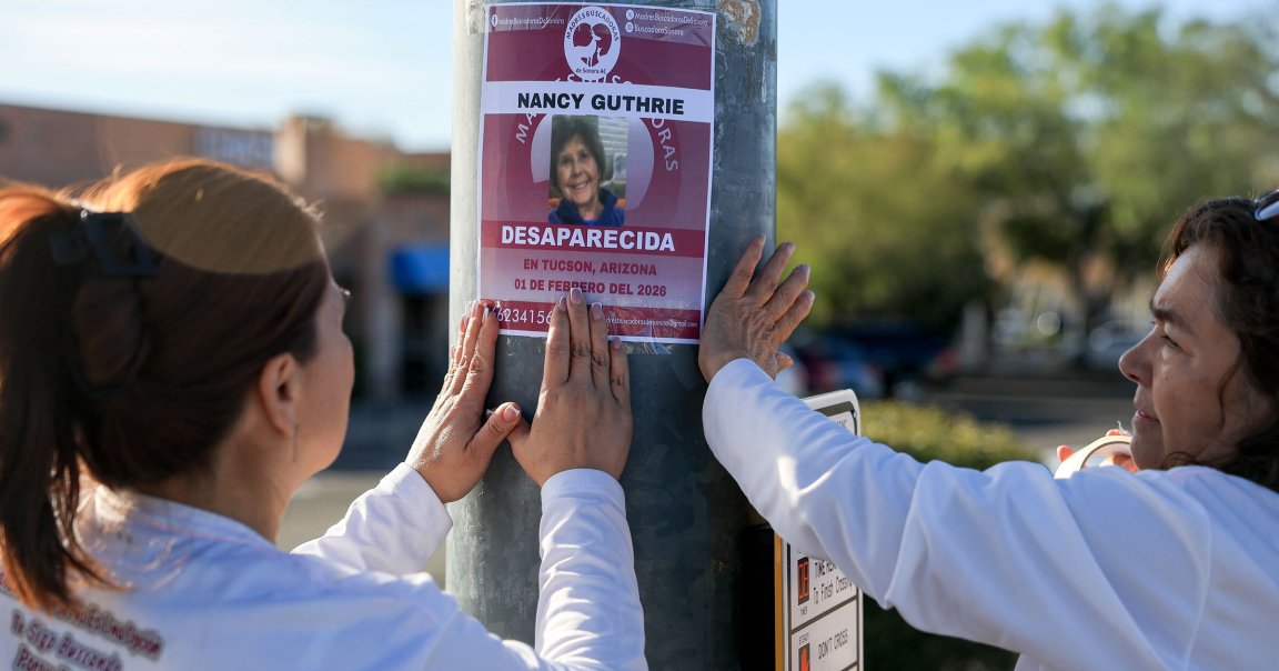 Volunteers putting up flyers for the search of Nancy Guthrie following her disappearance.