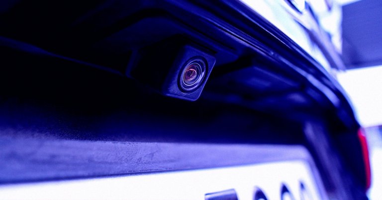 A color-treated photo of a car backup camera.