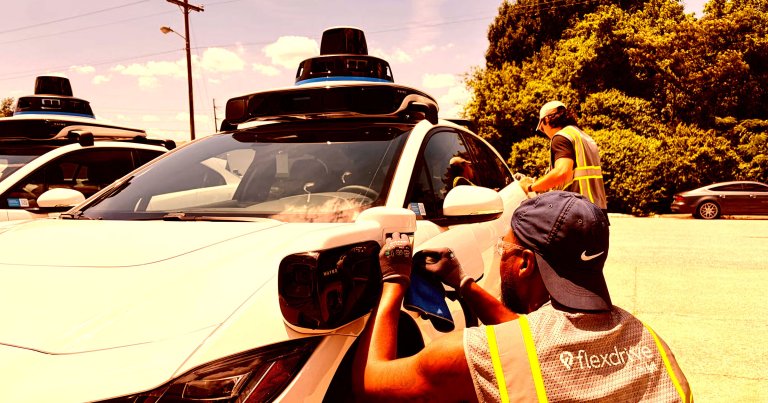 A man inspects a Waymo at the company's Nashville depot.