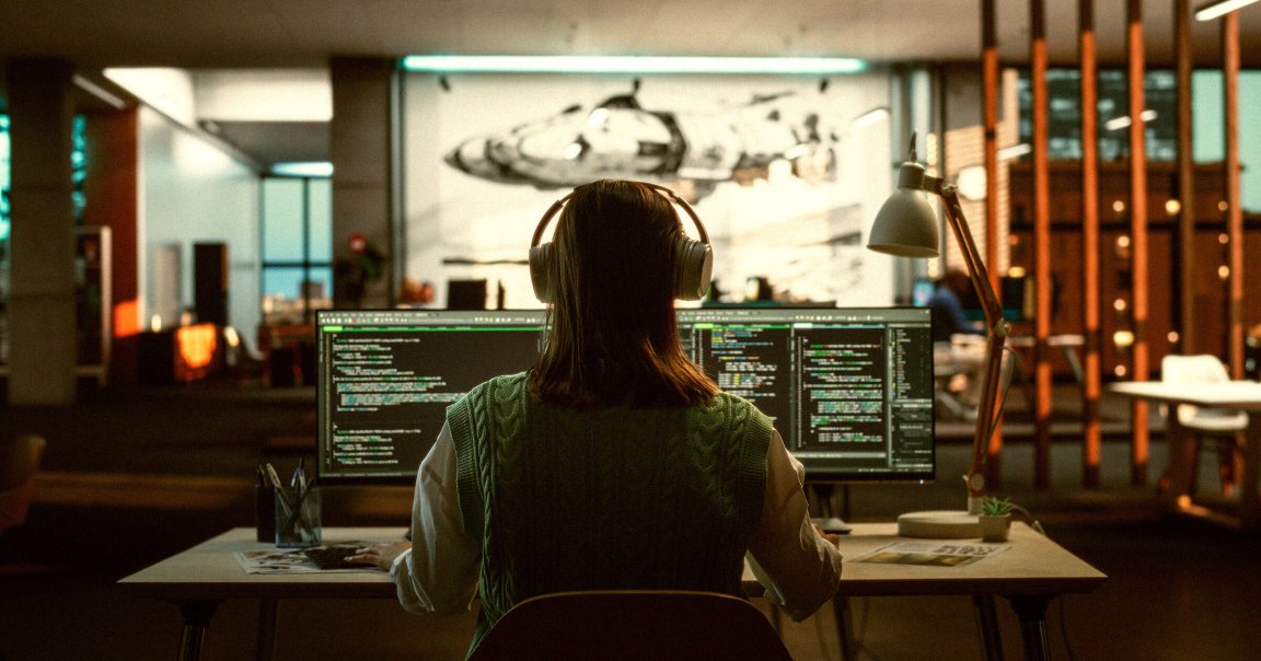 A photo of a professional programmer using headphones.