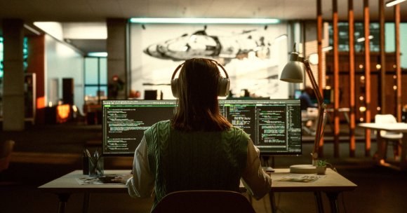 A photo of a professional programmer using headphones.