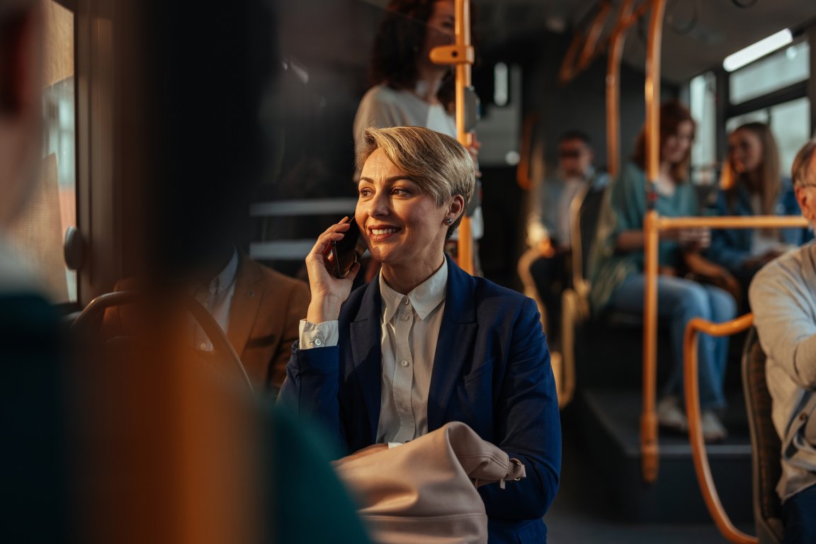 A smiling woman is enjoying a beautiful public transportation system.