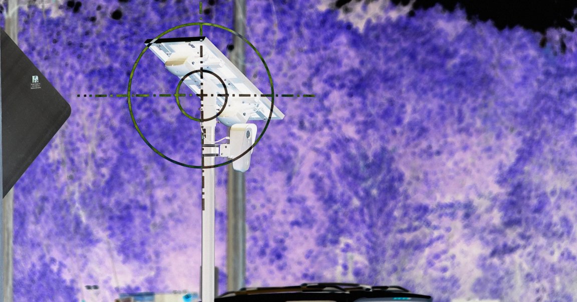 A photo illustration of a Flock camera pole.