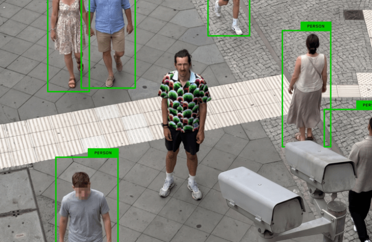 A photo shows a man wearing a shirt with a strange pattern while security cameras fail to flag him as human.