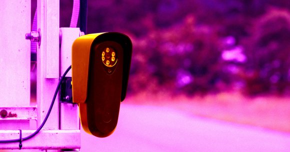 A color-treated photo of a Flock camera.