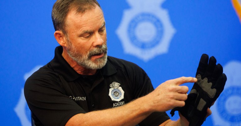 Omaha Police Officer Jason Cvitanov points out the contact pads on the Compliant Technologies G.L.O.V.E. during an interview.