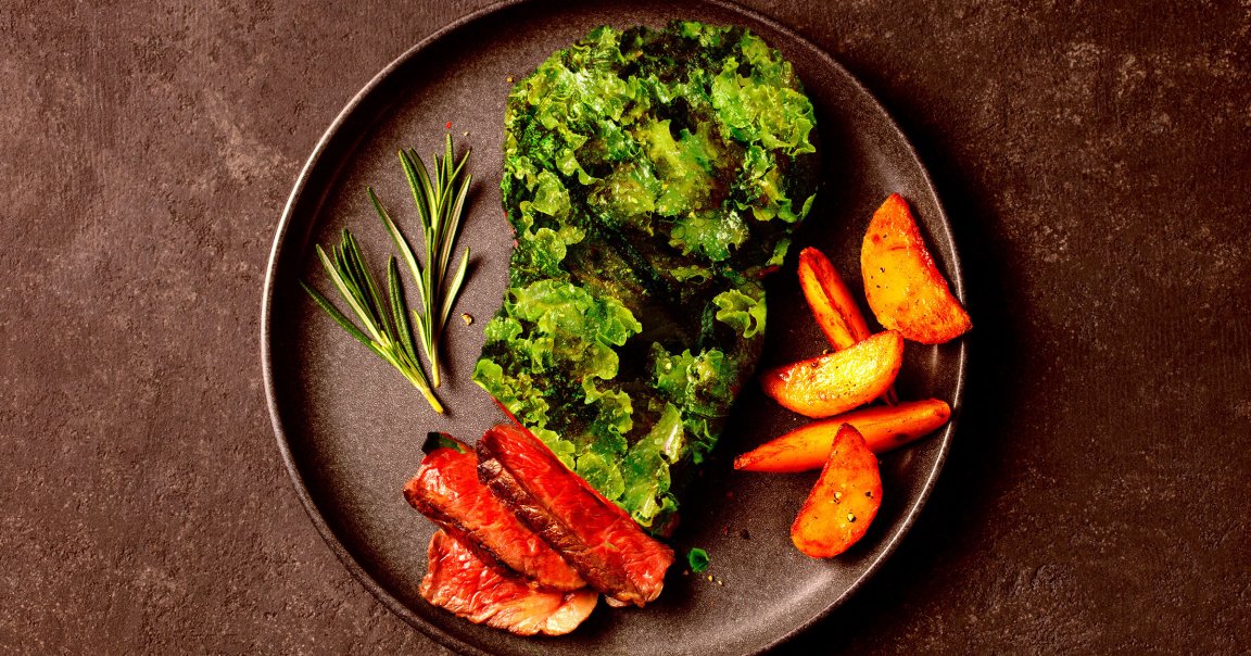 A photo illustration of a steak made out of lettuce.