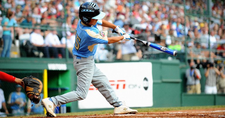 A Waipio Little League team player hits a home run during the World Series Championship.