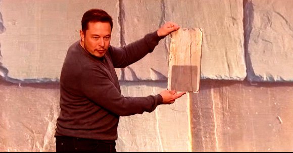 A screenshot of Tesla CEO Elon Musk showing off the company's Solar Roof tiles.