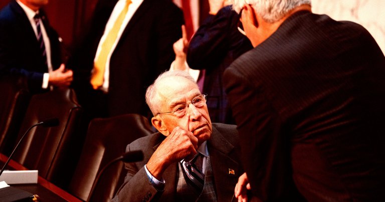 Chairman Chuck Grassley, R-Iowa, seated, talks with Sen. Sheldon Whitehouse, D-R.I., before the Senate Judiciary Committee markup.