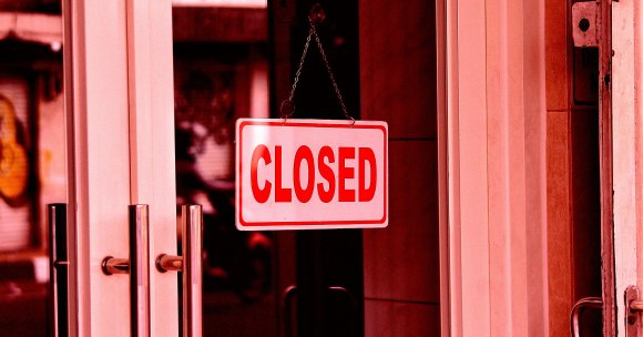 A color-treated photo of a closed sign on the door of a business.