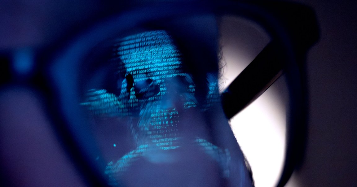A digital skull reflected in glasses.