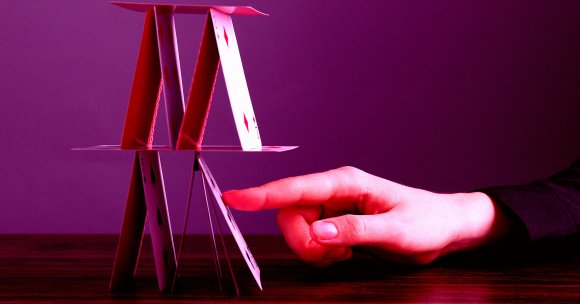 A house of cards being tipped over.
