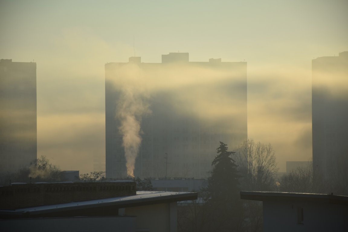A stock photo shows a large building obscured by smog.