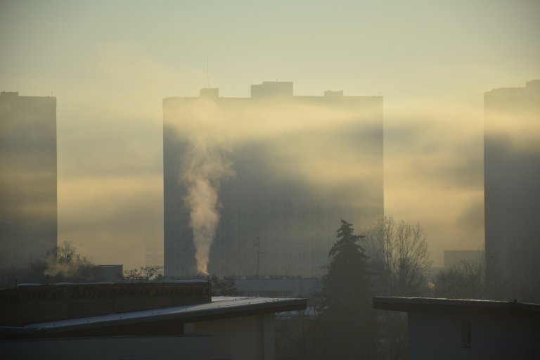 A stock photo shows a large building obscured by smog.