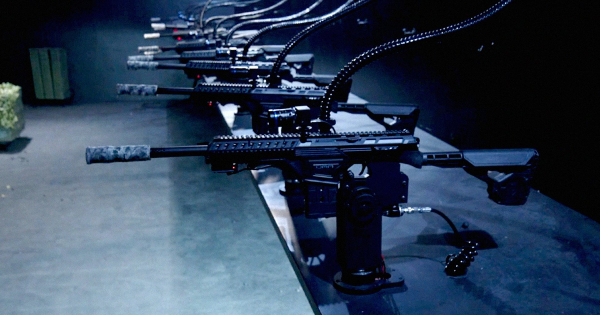 A screenshot of a row of guns aimed at targets.