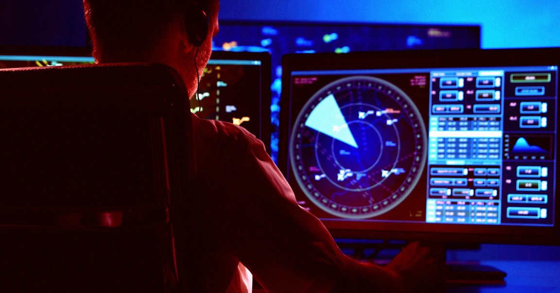 An air traffic controller at a desk.
