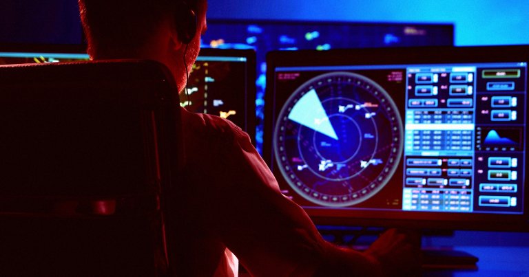 An air traffic controller at a desk.